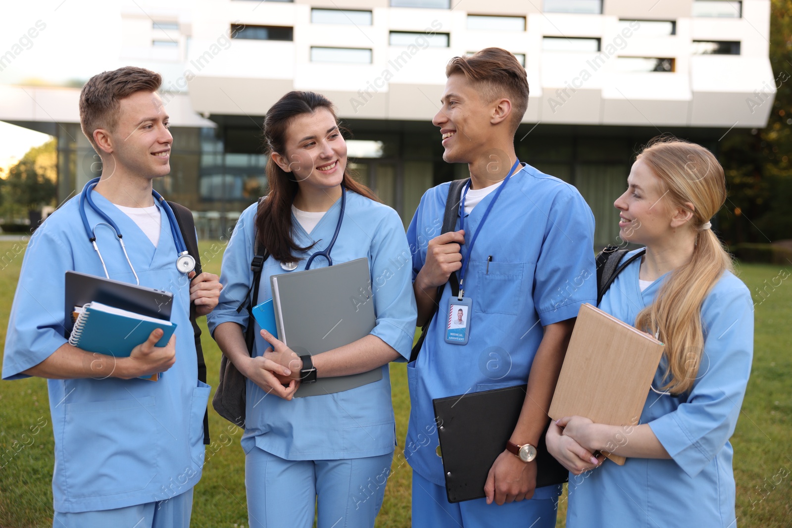 Group of medical students in uniforms near building outdoors Photo of Group of medical students in uniforms near building outdoors