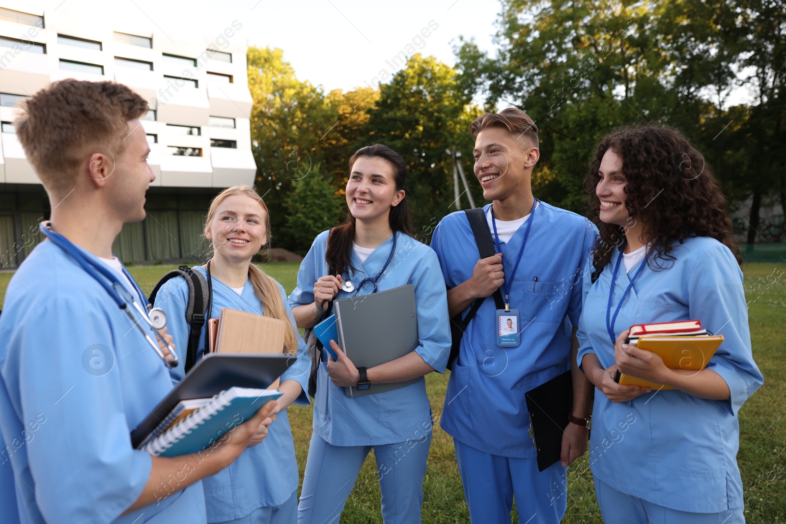 Group of medical students in uniforms near building outdoors Photo of Group of medical students in uniforms near building outdoors