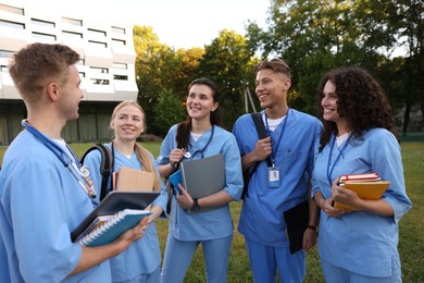 Photo of Group of medical students in uniforms near building outdoors