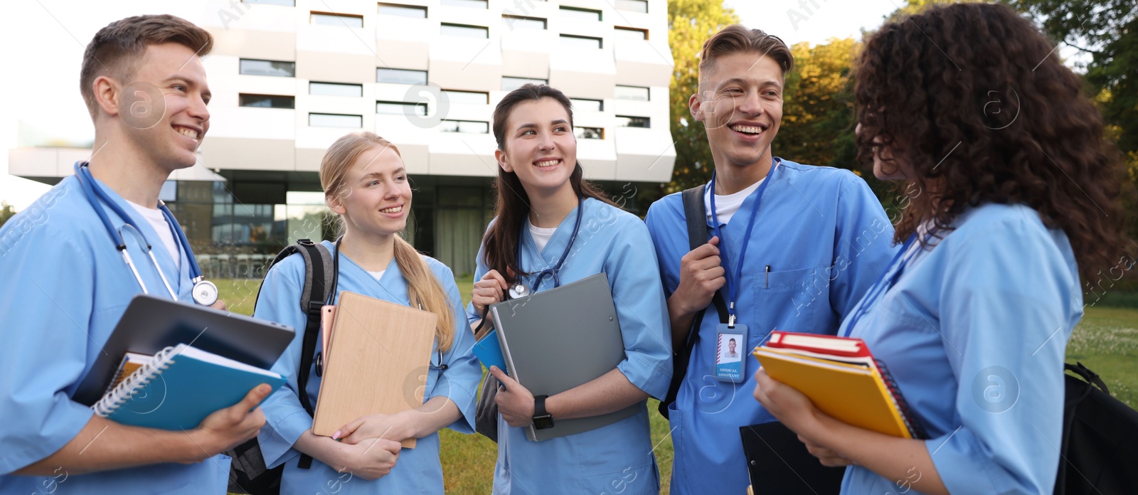 Photo of Group of medical students in uniforms near building outdoors