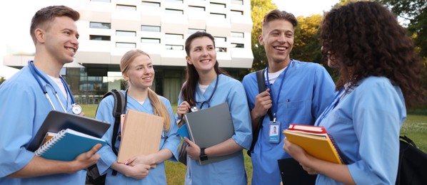 Photo of Group of medical students in uniforms near building outdoors