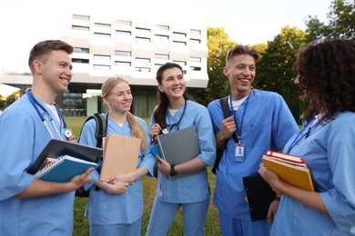 Photo of Group of medical students in uniforms near building outdoors