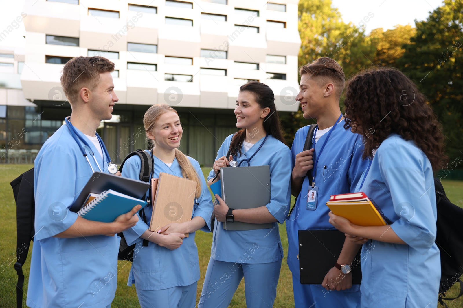 Group of medical students in uniforms near building outdoors Photo of Group of medical students in uniforms near building outdoors