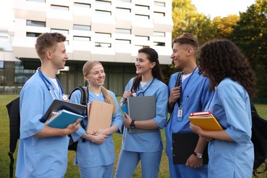 Photo of Group of medical students in uniforms near building outdoors