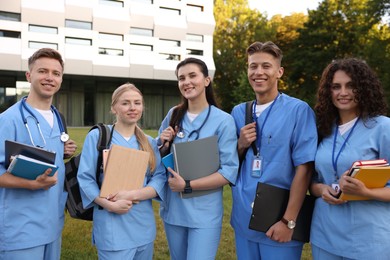 Photo of Group of medical students in uniforms near building outdoors