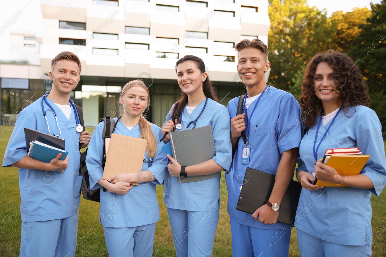 Group of medical students in uniforms near building outdoors Photo of Group of medical students in uniforms near building outdoors