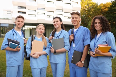 Photo of Group of medical students in uniforms near building outdoors
