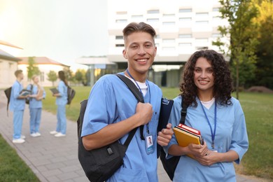 Photo of Medical students in uniforms outdoors, selective focus