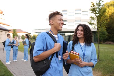 Photo of Medical students in uniforms outdoors, selective focus