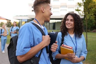 Photo of Medical students in uniforms outdoors, selective focus