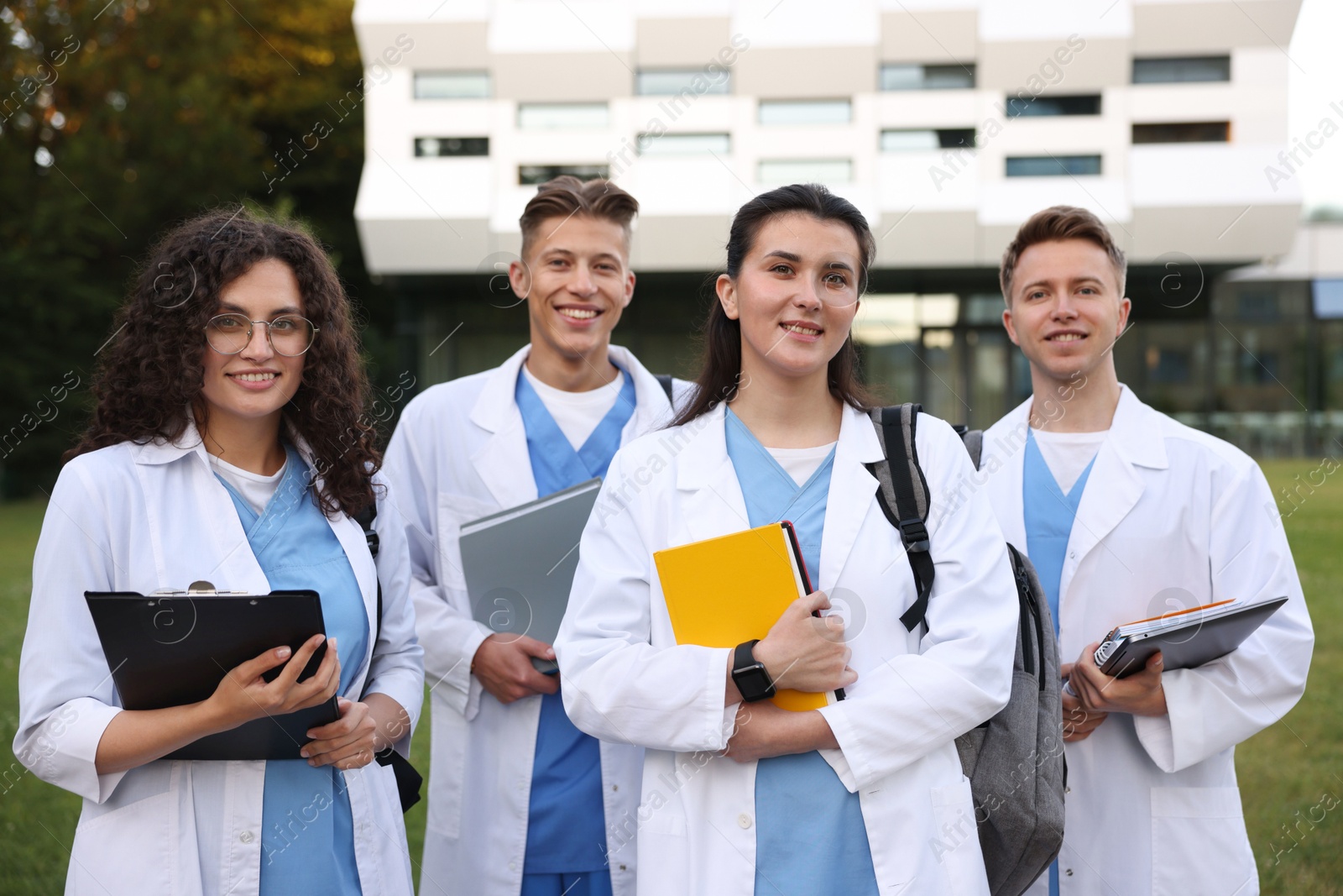 Photo of Group of medical students in uniforms near building outdoors