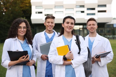 Photo of Group of medical students in uniforms near building outdoors