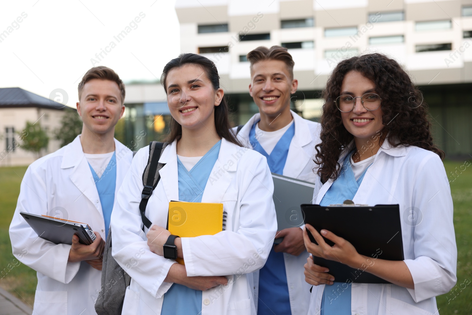 Photo of Group of medical students in uniforms near building outdoors
