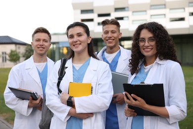Photo of Group of medical students in uniforms near building outdoors