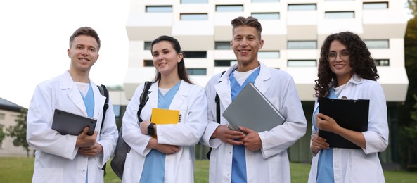 Photo of Group of medical students in uniforms near building outdoors