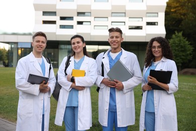 Photo of Group of medical students in uniforms near building outdoors