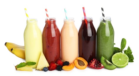 Photo of Superfood. Tasty smoothies in glass bottles and ingredients isolated on white