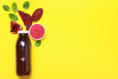 Photo of Superfood. Tasty smoothie in glass bottle and ingredients on yellow background, flat lay. Space for text