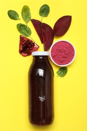 Photo of Superfood. Tasty smoothie in glass bottle and ingredients on yellow background, flat lay