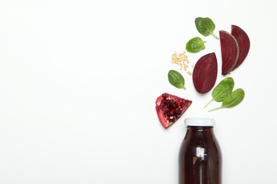 Photo of Superfood. Tasty smoothie in glass bottle and ingredients on white background, top view. Space for text