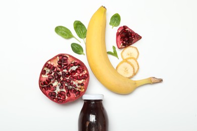 Photo of Superfood. Tasty smoothie in glass bottle and ingredients on white background, top view