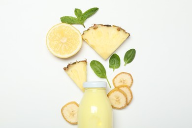 Photo of Superfood. Tasty smoothie in glass bottle and ingredients on white background, top view