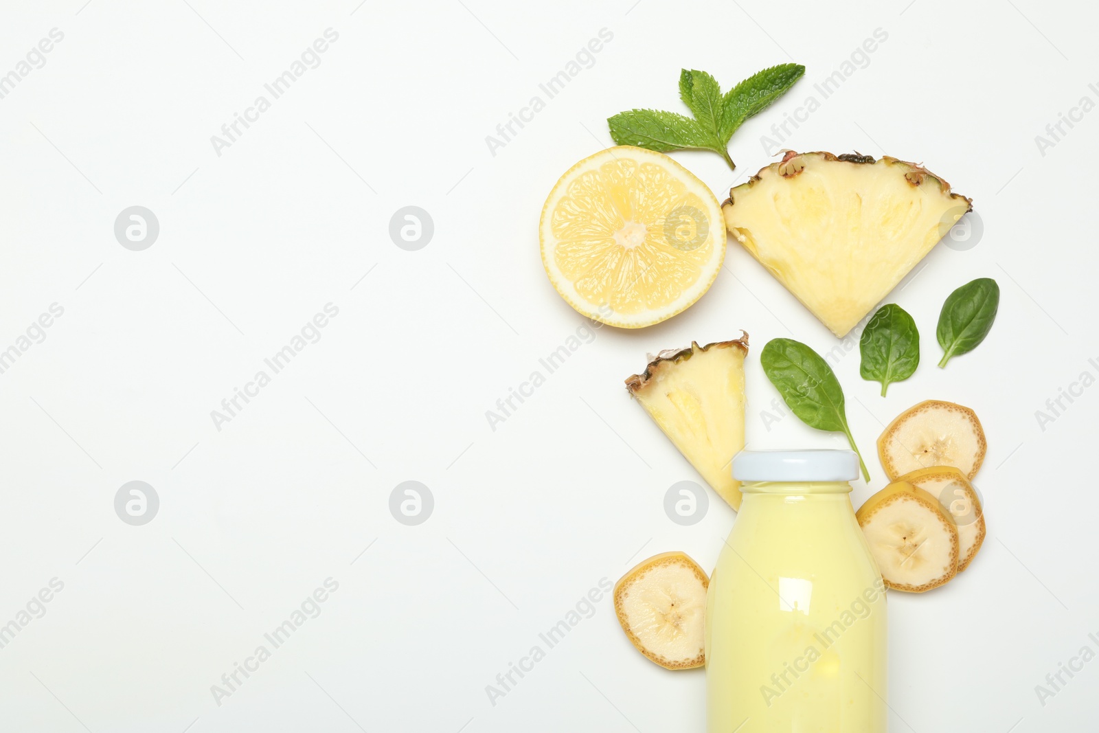 Superfood. Tasty smoothie in glass bottle and ingredients on white background, top view. Space for text Photo of Superfood. Tasty smoothie in glass bottle and ingredients on white background, top view. Space for text