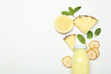 Photo of Superfood. Tasty smoothie in glass bottle and ingredients on white background, top view. Space for text