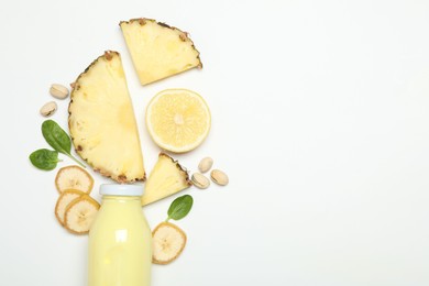 Photo of Superfood. Tasty smoothie in glass bottle and ingredients on white background, top view. Space for text