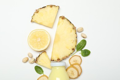 Photo of Superfood. Tasty smoothie in glass bottle and ingredients on white background, top view