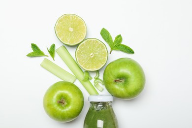 Photo of Superfood. Tasty smoothie in glass bottle and ingredients on white background, top view