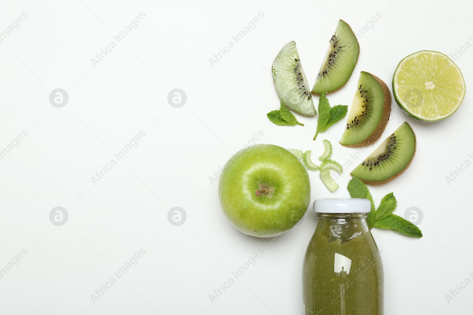 Photo of Superfood. Tasty smoothie in glass bottle and ingredients on white background, top view. Space for text