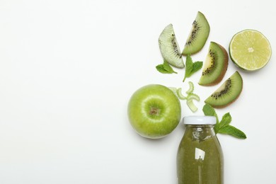 Photo of Superfood. Tasty smoothie in glass bottle and ingredients on white background, top view. Space for text