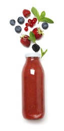 Photo of Superfood. Tasty smoothie in glass bottle and ingredients isolated on white, top view