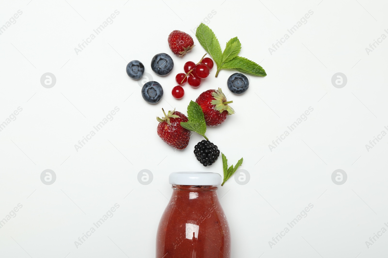 Superfood. Tasty smoothie in glass bottle and ingredients on white background, top view Photo of Superfood. Tasty smoothie in glass bottle and ingredients on white background, top view