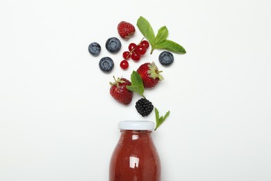 Photo of Superfood. Tasty smoothie in glass bottle and ingredients on white background, top view