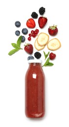 Photo of Superfood. Tasty smoothie in glass bottle and ingredients isolated on white, top view