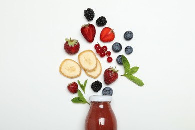 Photo of Superfood. Tasty smoothie in glass bottle and ingredients on white background, top view