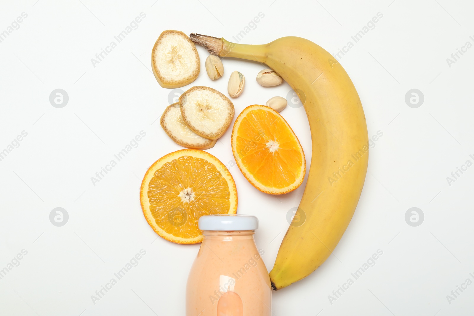Photo of Superfood. Tasty smoothie in glass bottle and ingredients on white background, top view