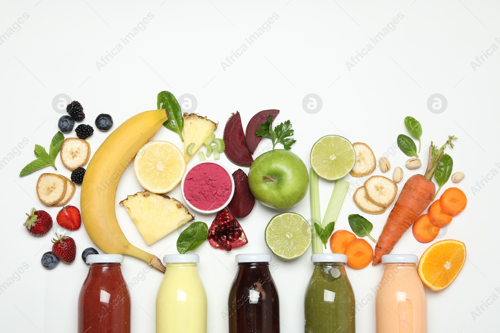 Photo of Superfood. Tasty smoothie in glass bottle and ingredients on white background, top view