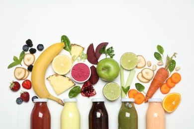 Photo of Superfood. Tasty smoothie in glass bottle and ingredients on white background, top view