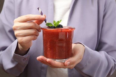 Photo of Superfood. Woman with glass of tasty smoothie, closeup