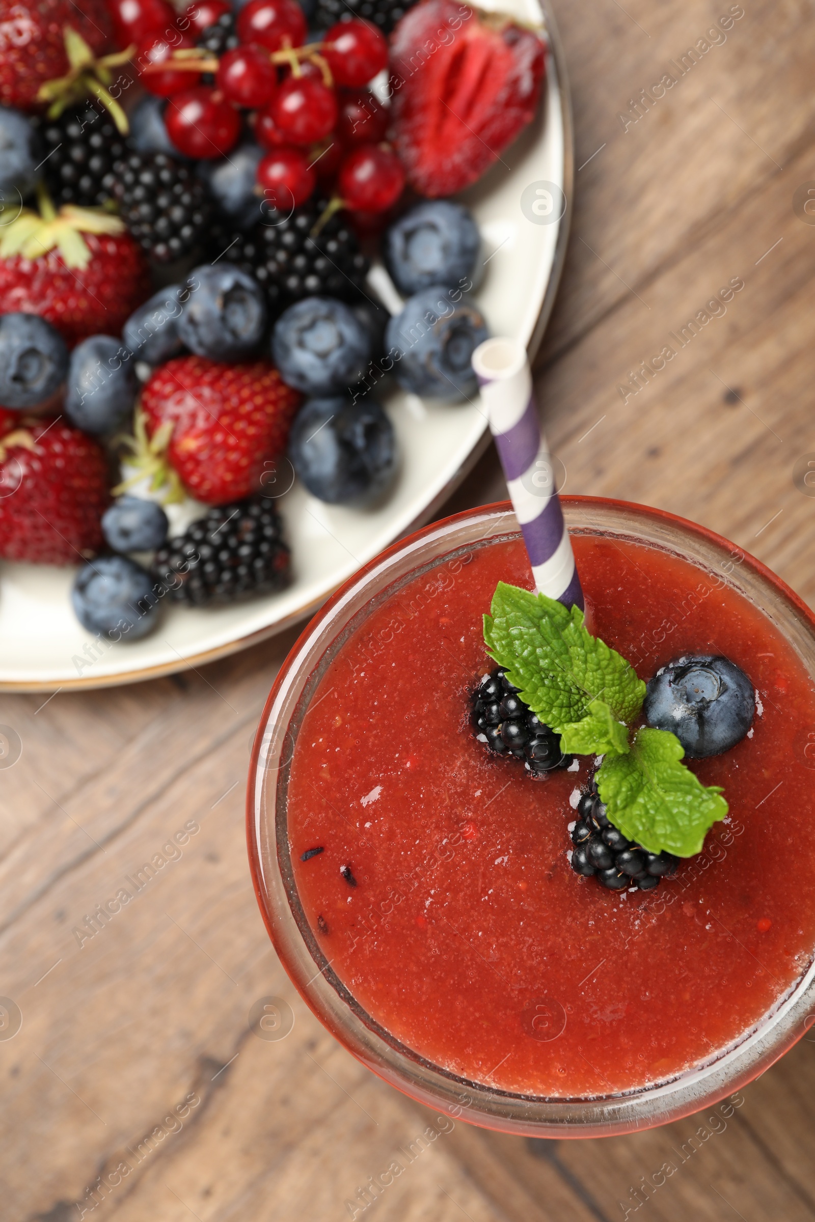 Superfood. Tasty smoothie in glass and ingredients on wooden table, flat lay Photo of Superfood. Tasty smoothie in glass and ingredients on wooden table, flat lay