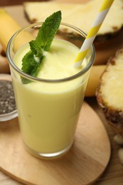 Photo of Superfood. Tasty smoothie in glass and ingredients on table, closeup