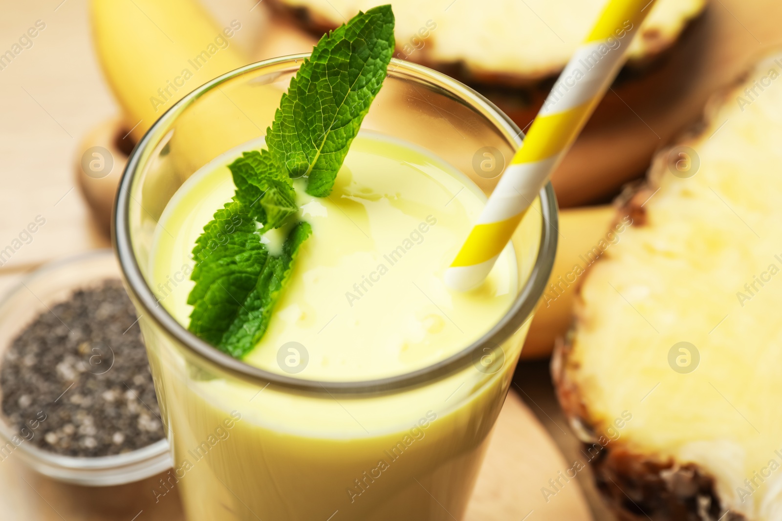 Superfood. Tasty smoothie in glass and ingredients on table, closeup Photo of Superfood. Tasty smoothie in glass and ingredients on table, closeup