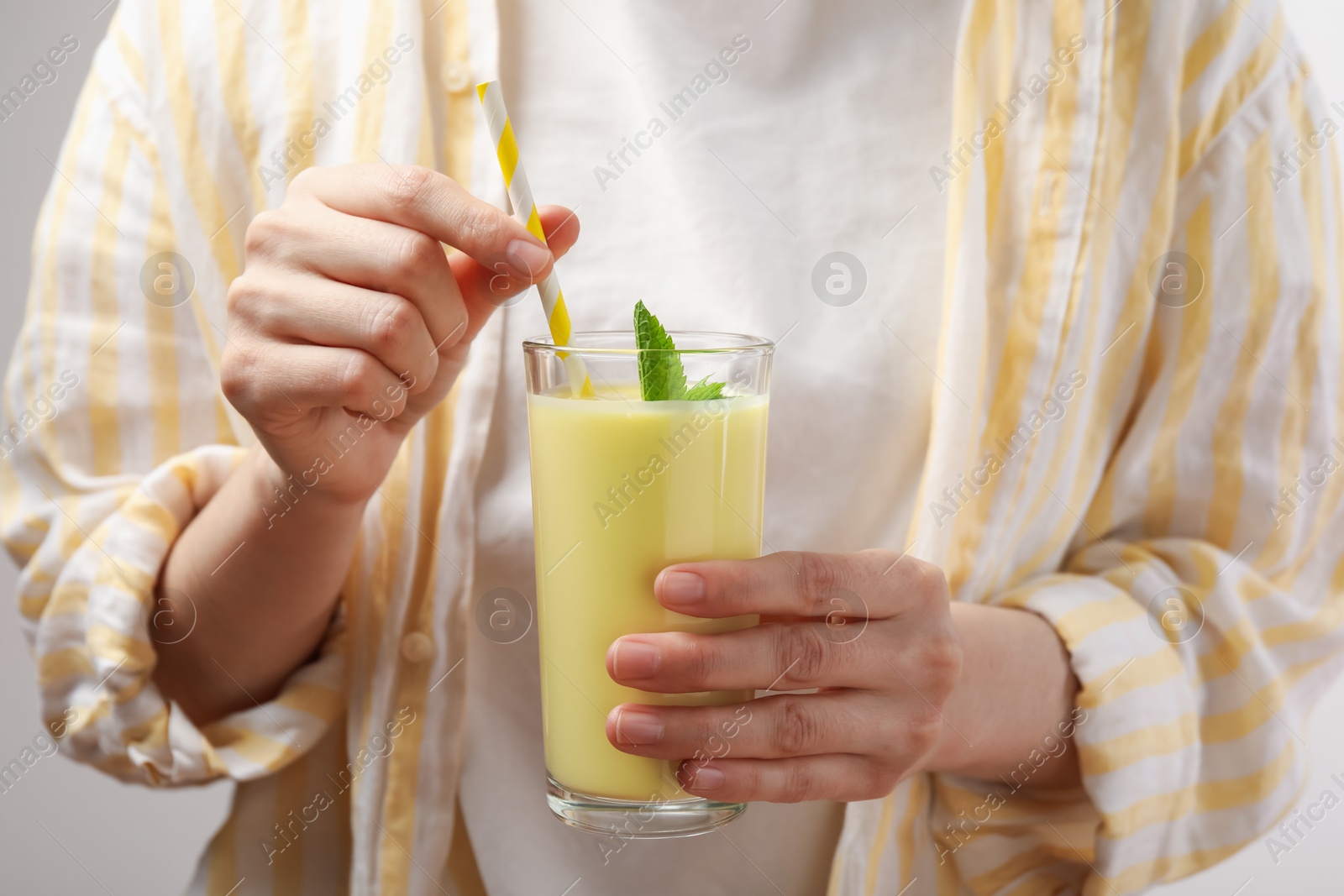 Superfood. Woman with glass of tasty smoothie, closeup Photo of Superfood. Woman with glass of tasty smoothie, closeup