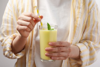 Photo of Superfood. Woman with glass of tasty smoothie, closeup