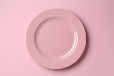 Photo of Stylish plate on pink background, top view