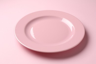 Photo of One stylish plate on pink background, closeup