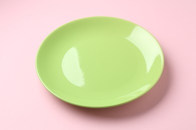 Photo of One stylish plate on pink background, closeup
